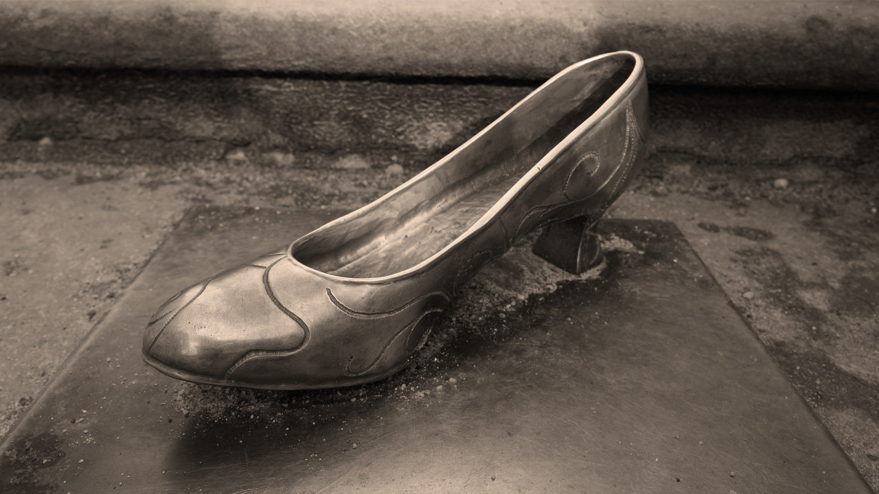 A metal sculpture of a woman's dress shoe.