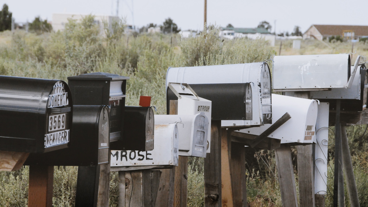 A row of mailboxes of various heights
