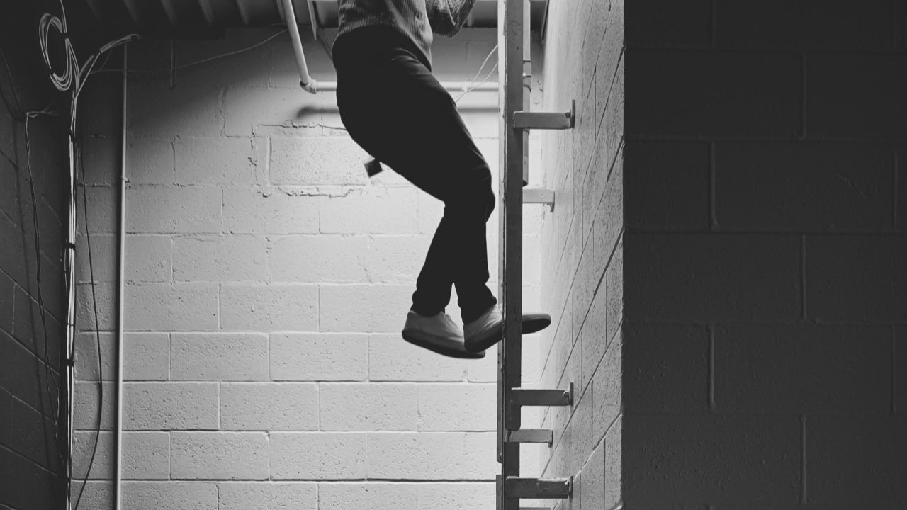 Descending a ladder.