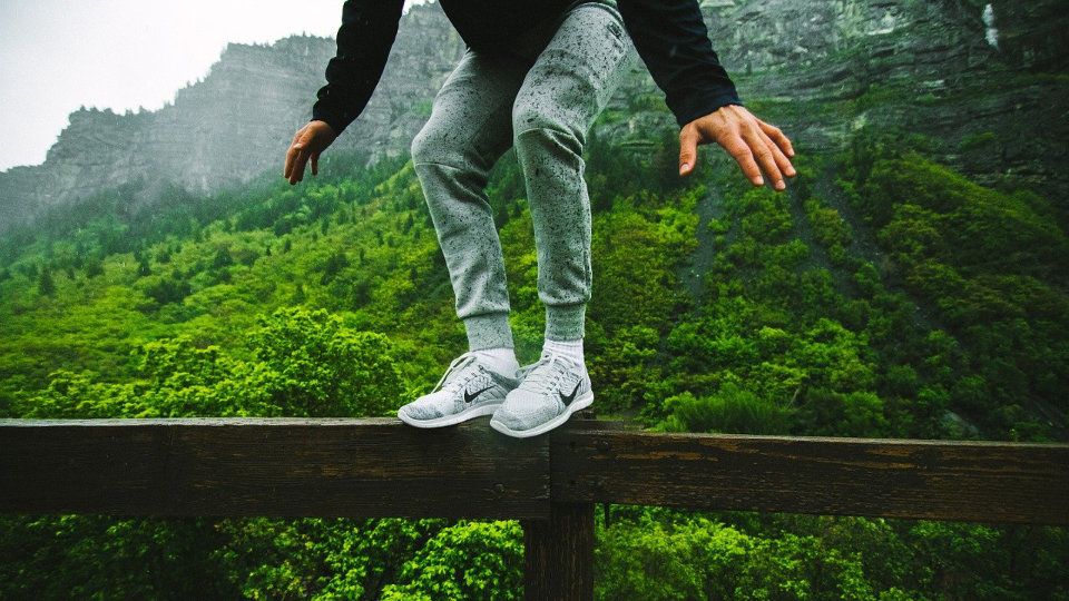 Young man balancing on a post