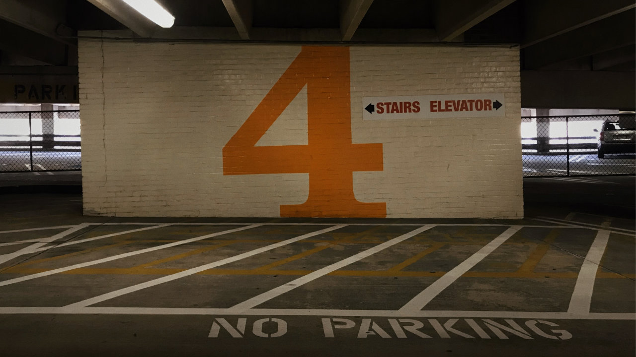 The number four in orange on a parking lot wall