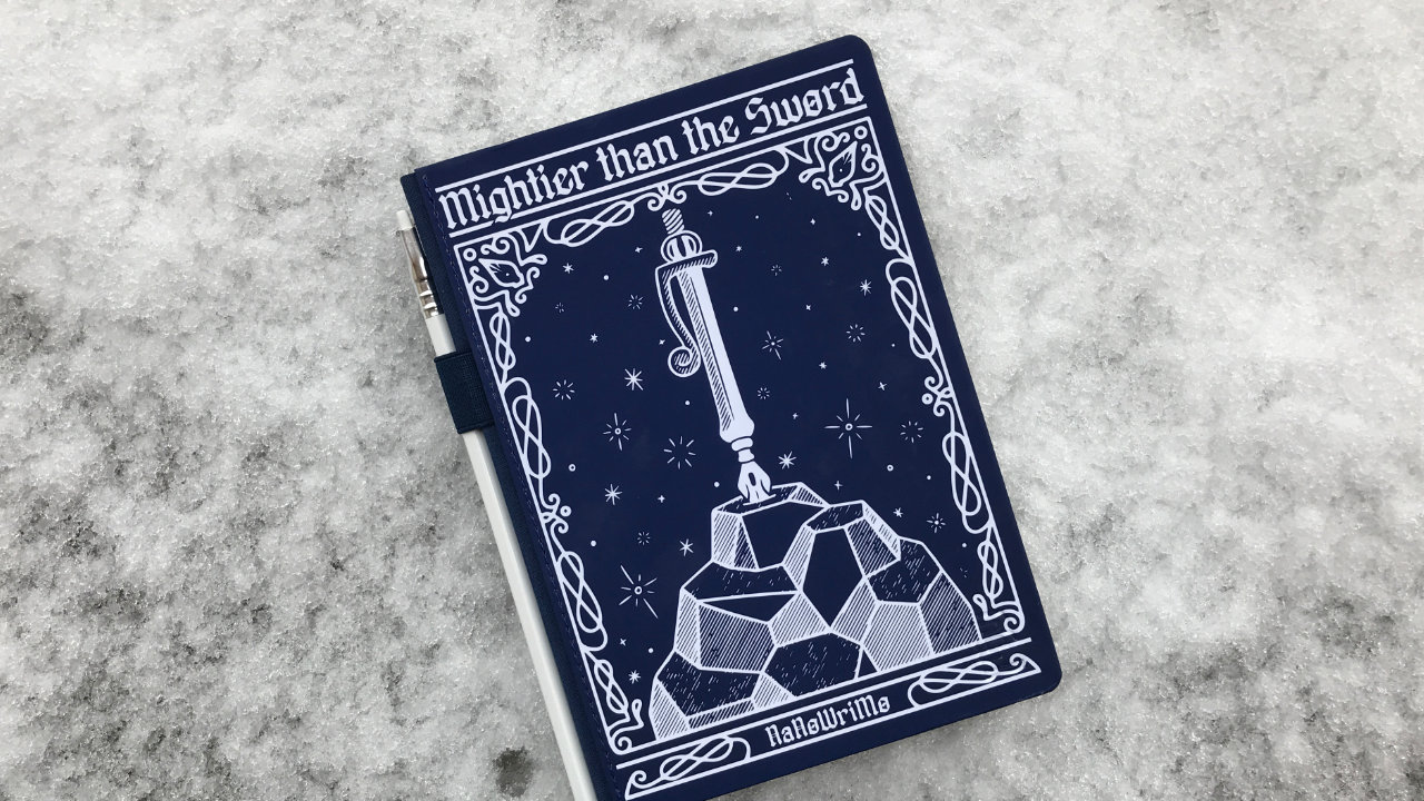 A blue notebook lying atop a pile of snow