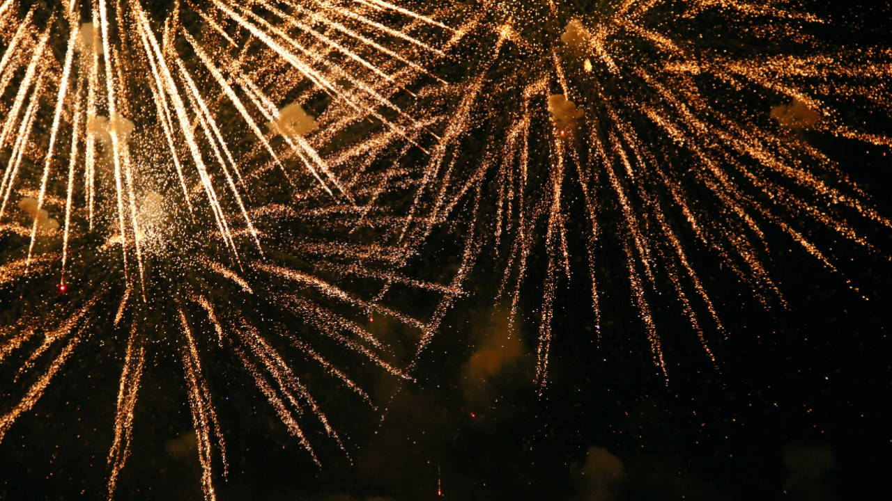 Bright fireworks exploding against a dark sky