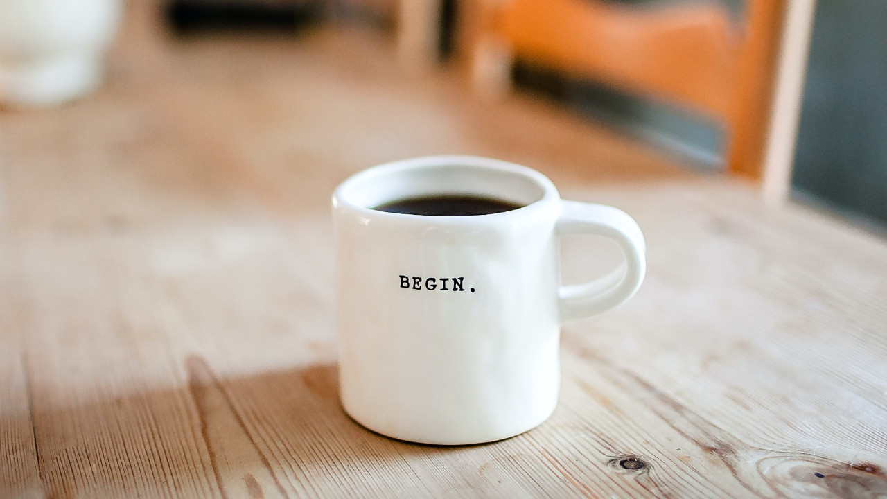 A white mug of black coffee