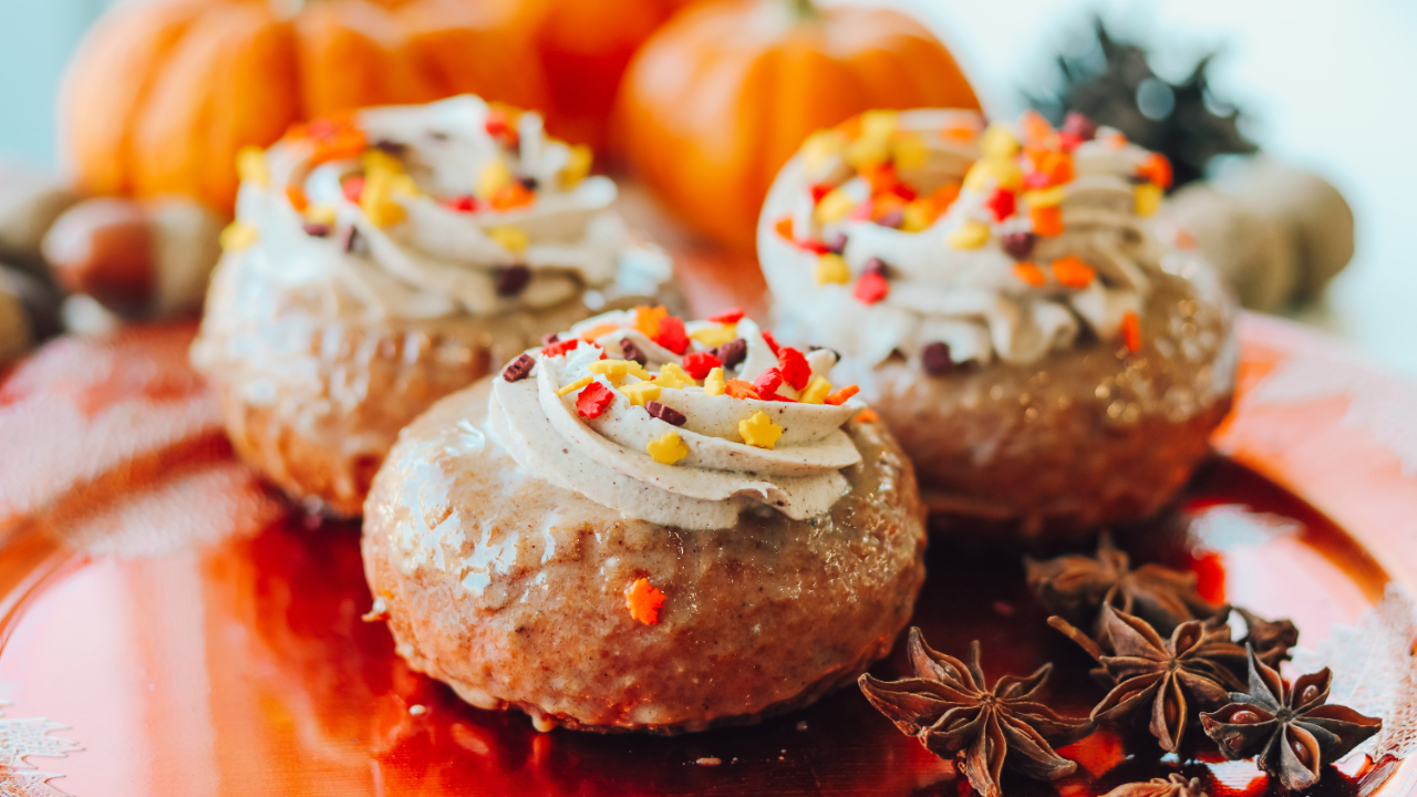 Pumpkin donuts with icing and sprinkles