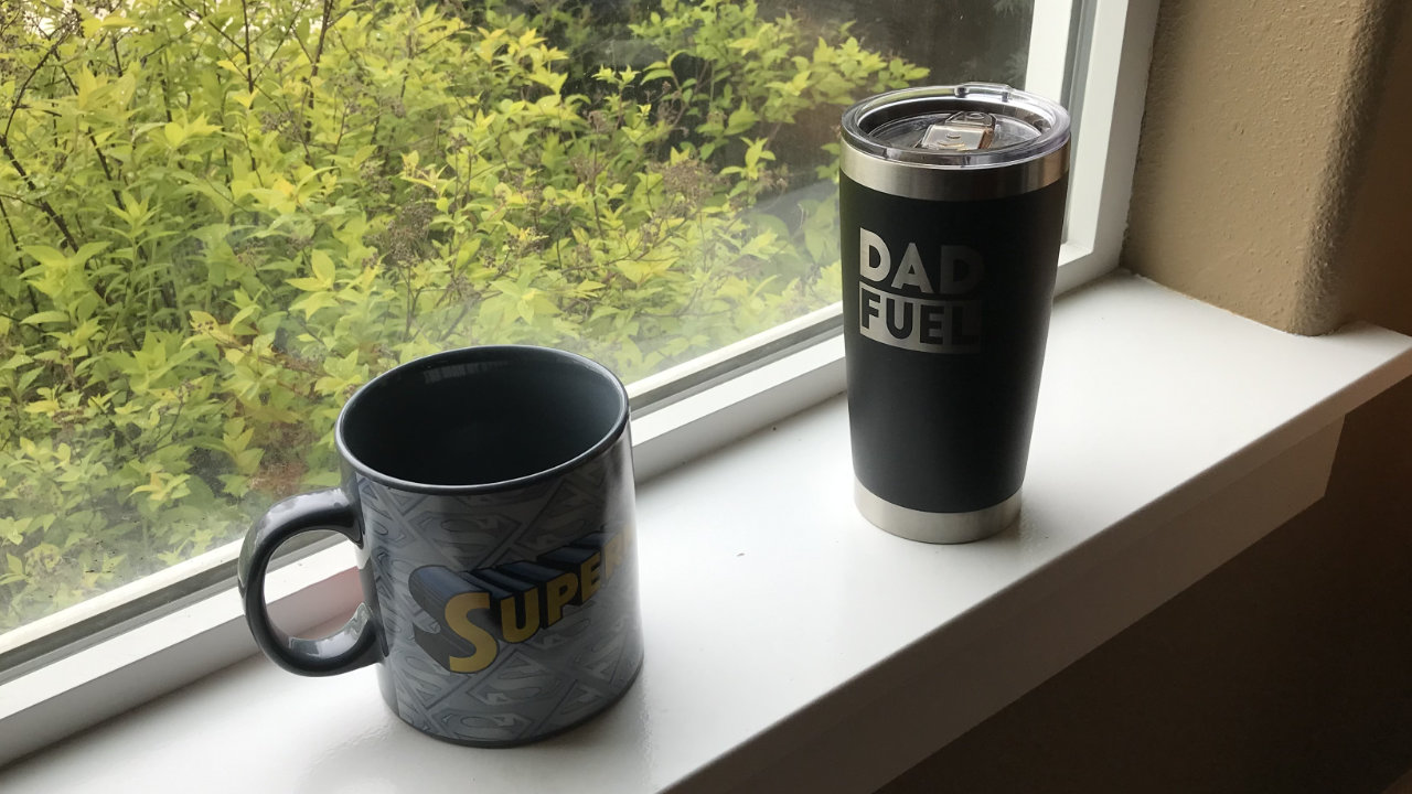 A ceramic Superman mug and a coffee tumbler