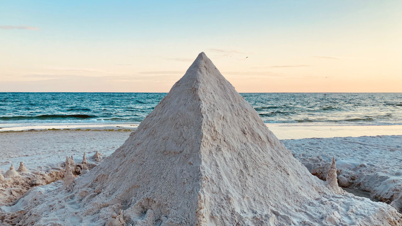 A mount of white sand in the shape of a pyramid
